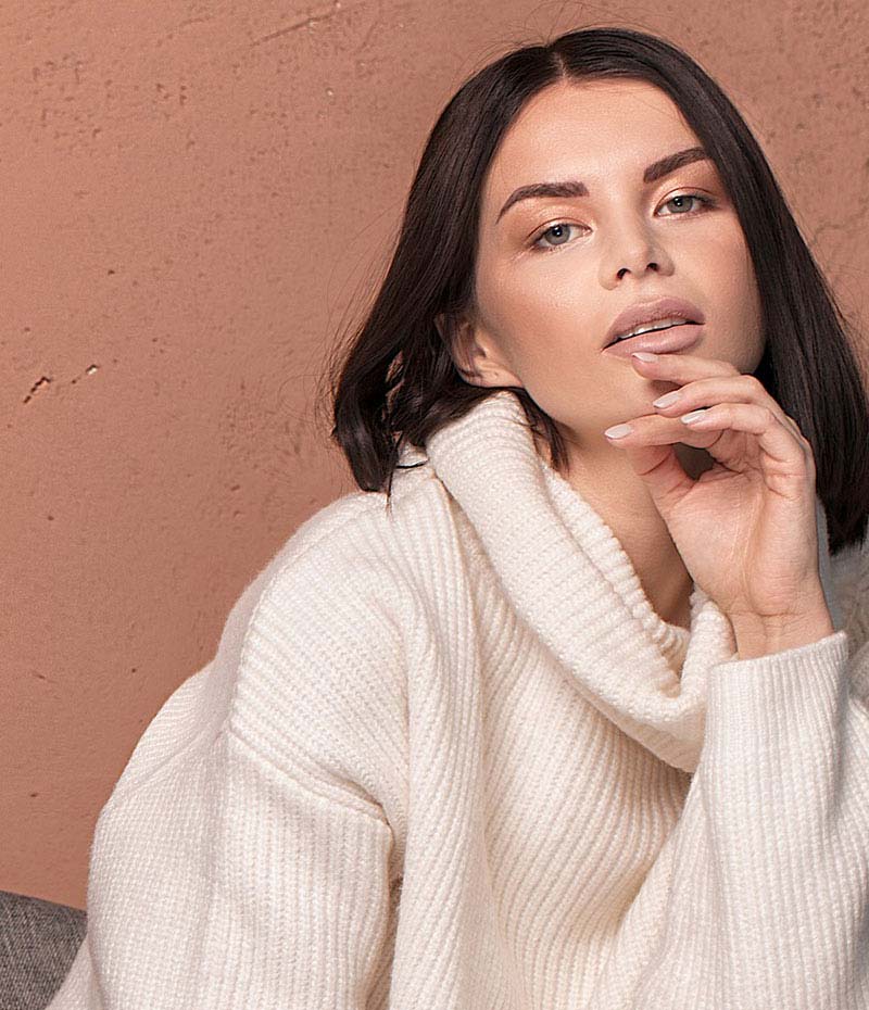 Brunette woman in a white sweater