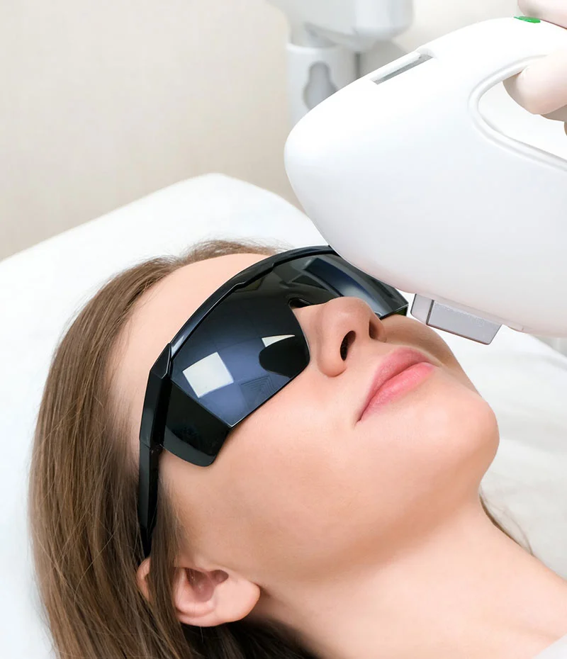 Woman receiving laser treatments to her face