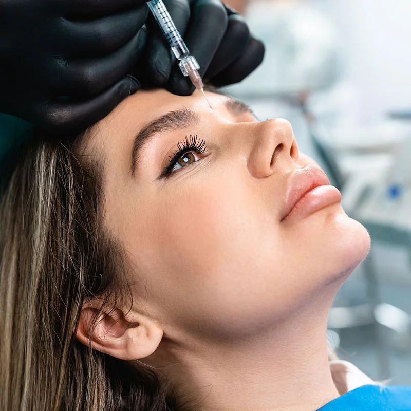 Woman getting PRP injections on her forehead